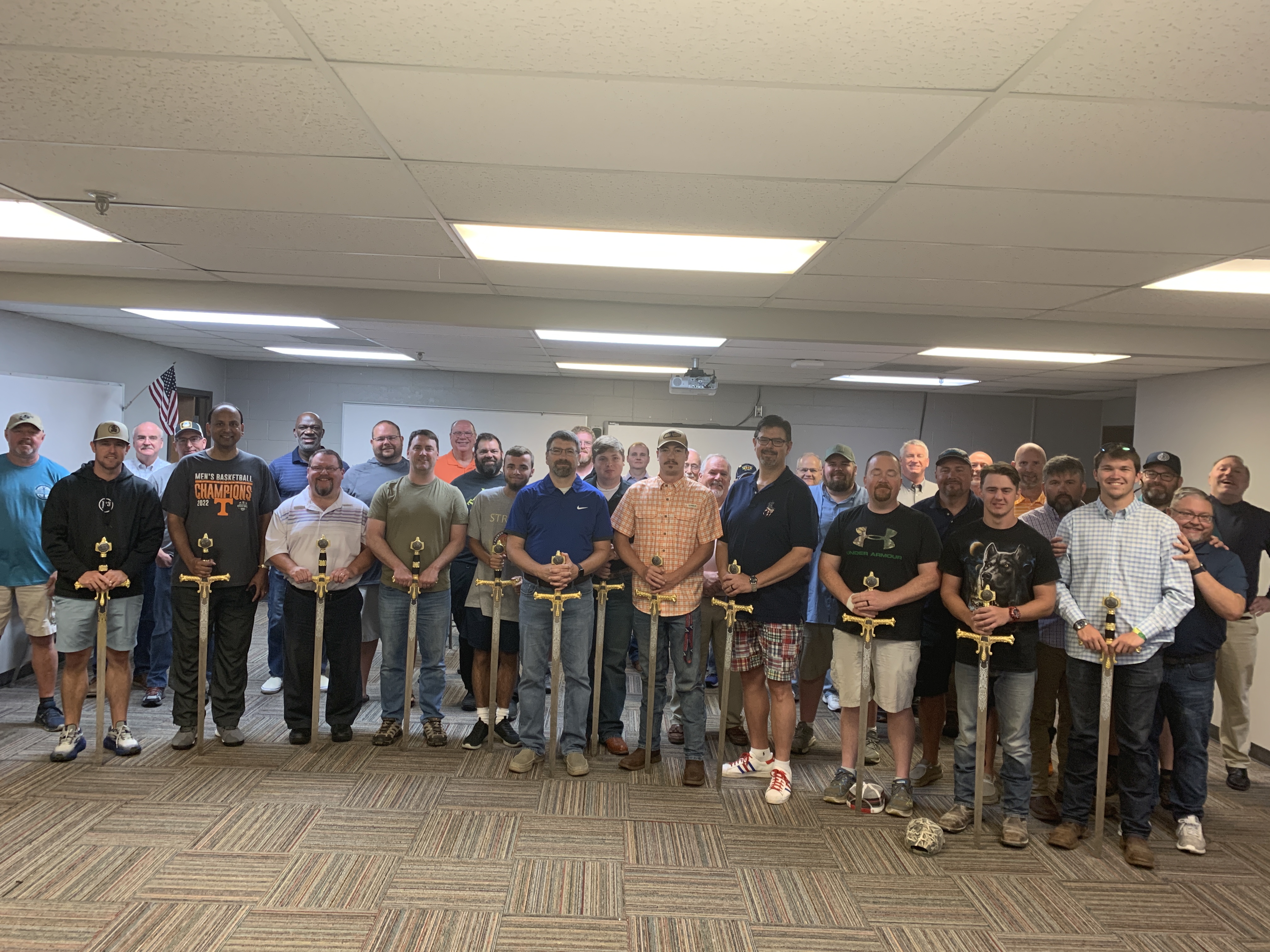 Fight for Manhood graduates gathered together with ceremonial swords